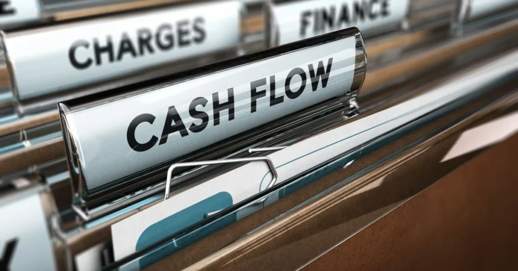Close-up of a labeled file tab reading 'Cash Flow' in a filing cabinet among other financial folders