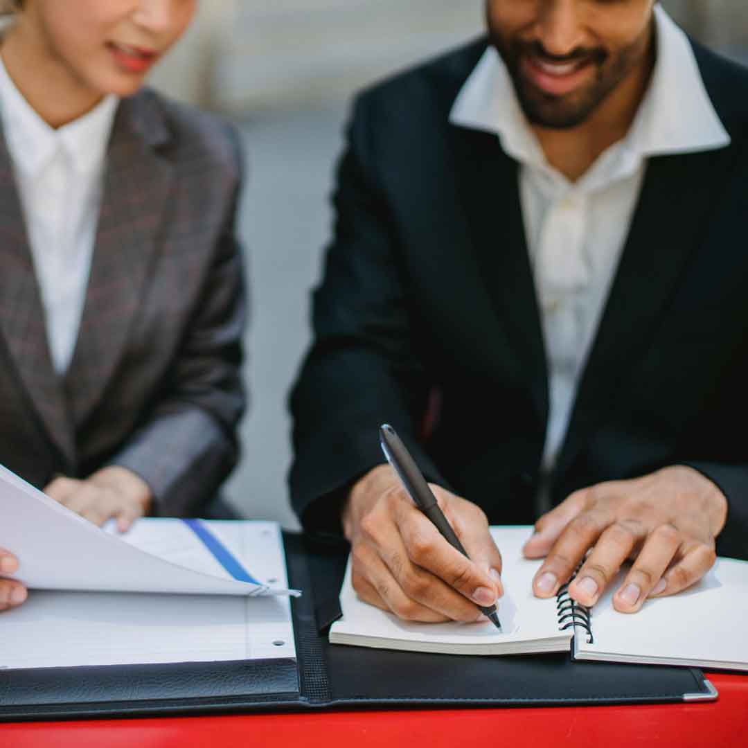 Two Taurus Collections team members working together at a desk