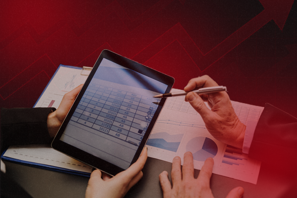 Debt collection agents analyzing account data on a tablet and financial reports